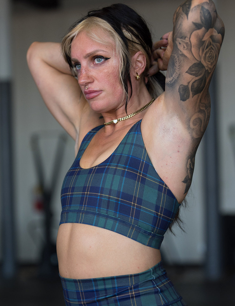 model wearing the blue, green, and yellow plaid bra