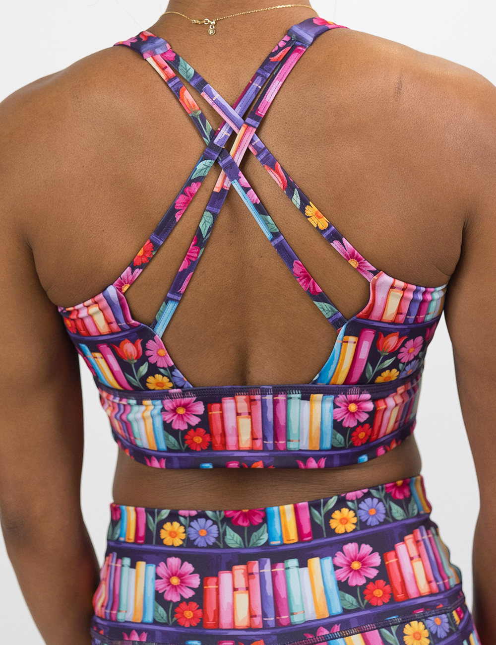 back of the brightly colored books and flours longline bra against a white background