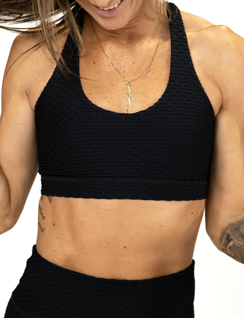 front of the black waffled texture bra against a white background