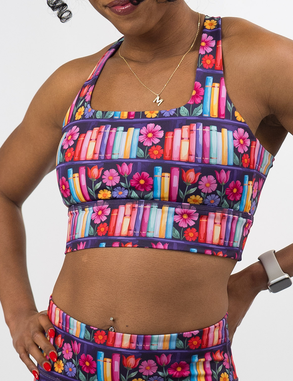 front of the brightly colored books and flowers long line bra against a white background
