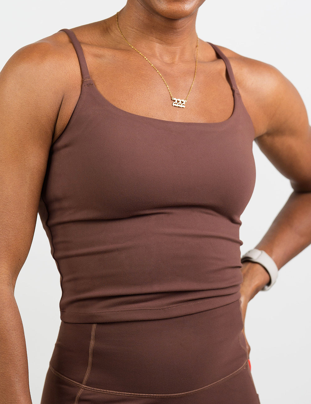 front of the light brown cami top against a white background