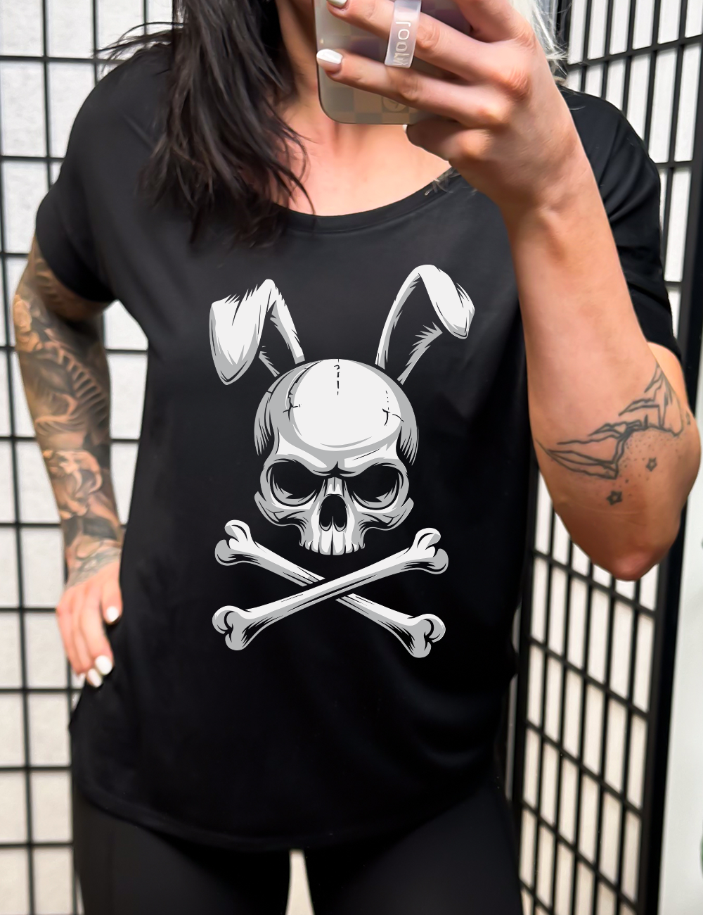 black slouchy tee with the large graphic of a skull and crossbones, and the skull has bunny ears 