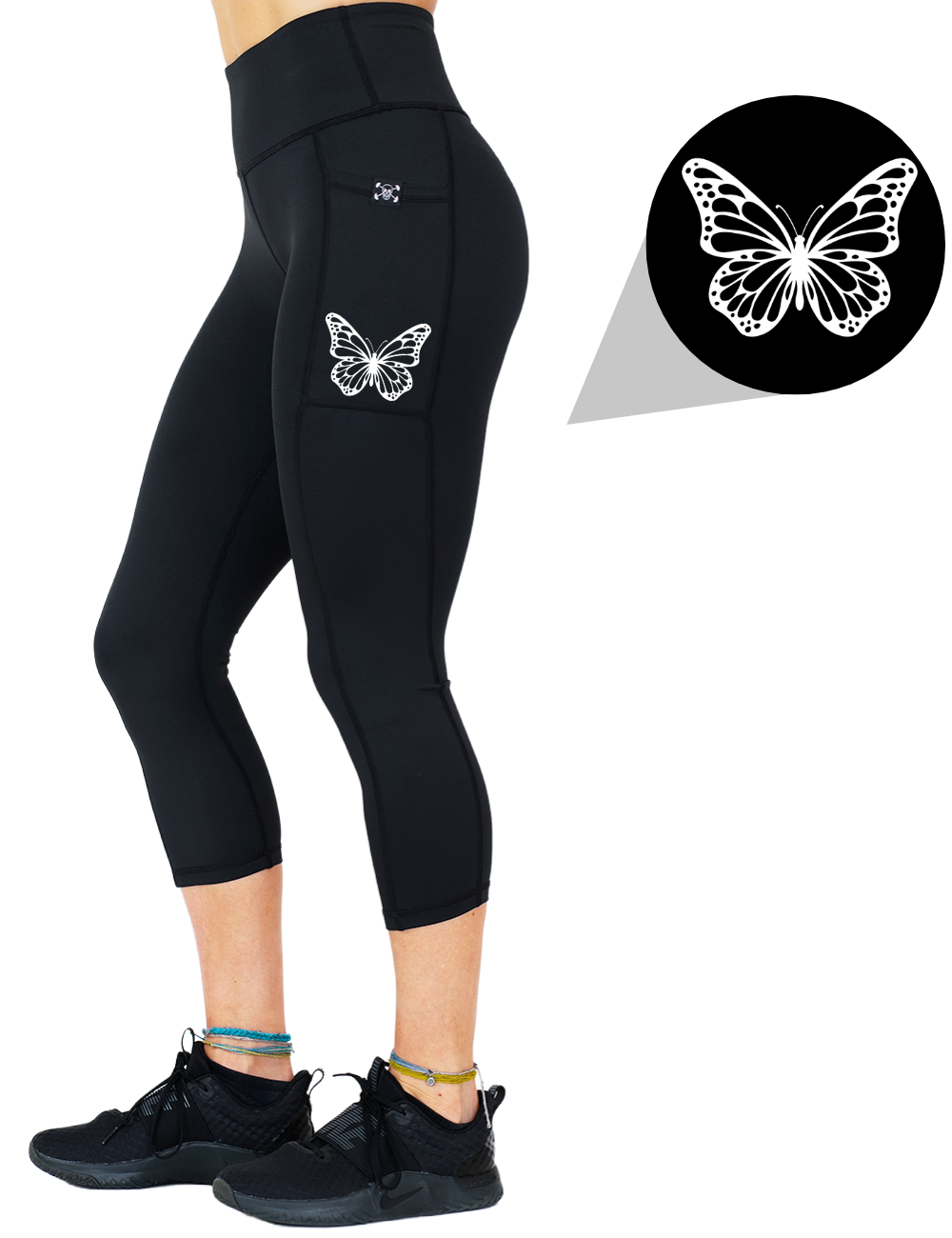 model wearing the butterfly graphic capri solid black leggings against a white background