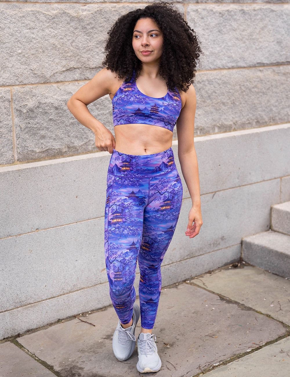 model wearing the full length lavender and blue floral full length leggings featuring traditional pagodas and blooming cherry trees 