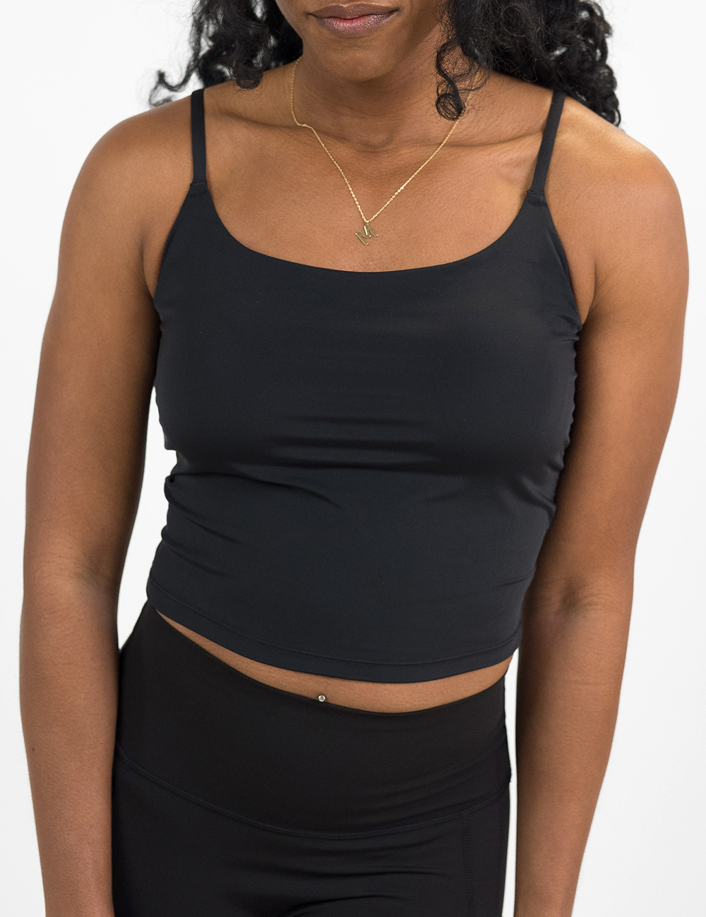 front of the black cami top against a white background
