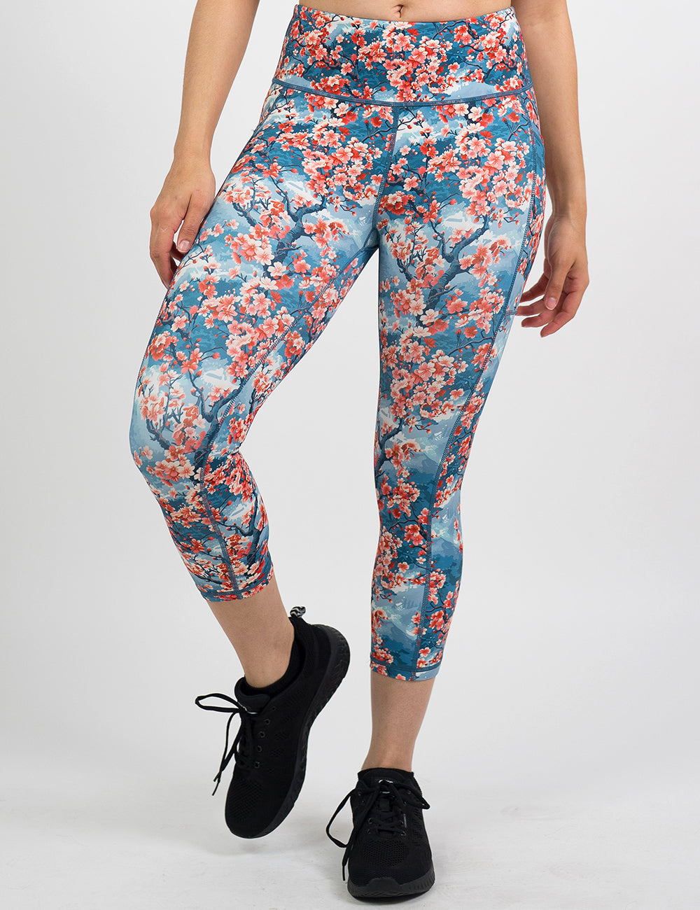 front of the cherry blossom tree capri leggings against a white background