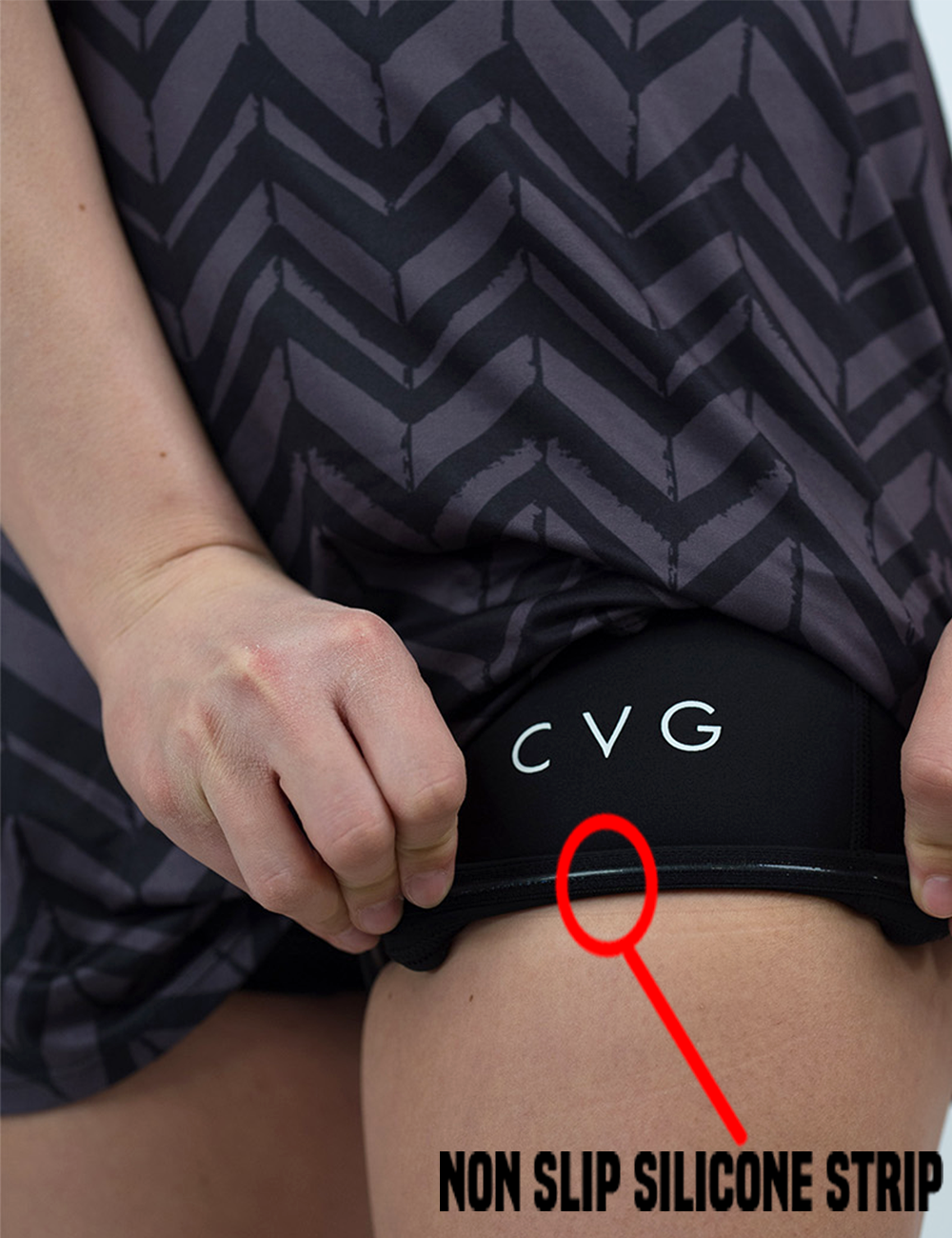 close up of the grey arrows against a black background active dress against a white background rolled up to show the non slip silicone strip lining in the shorts