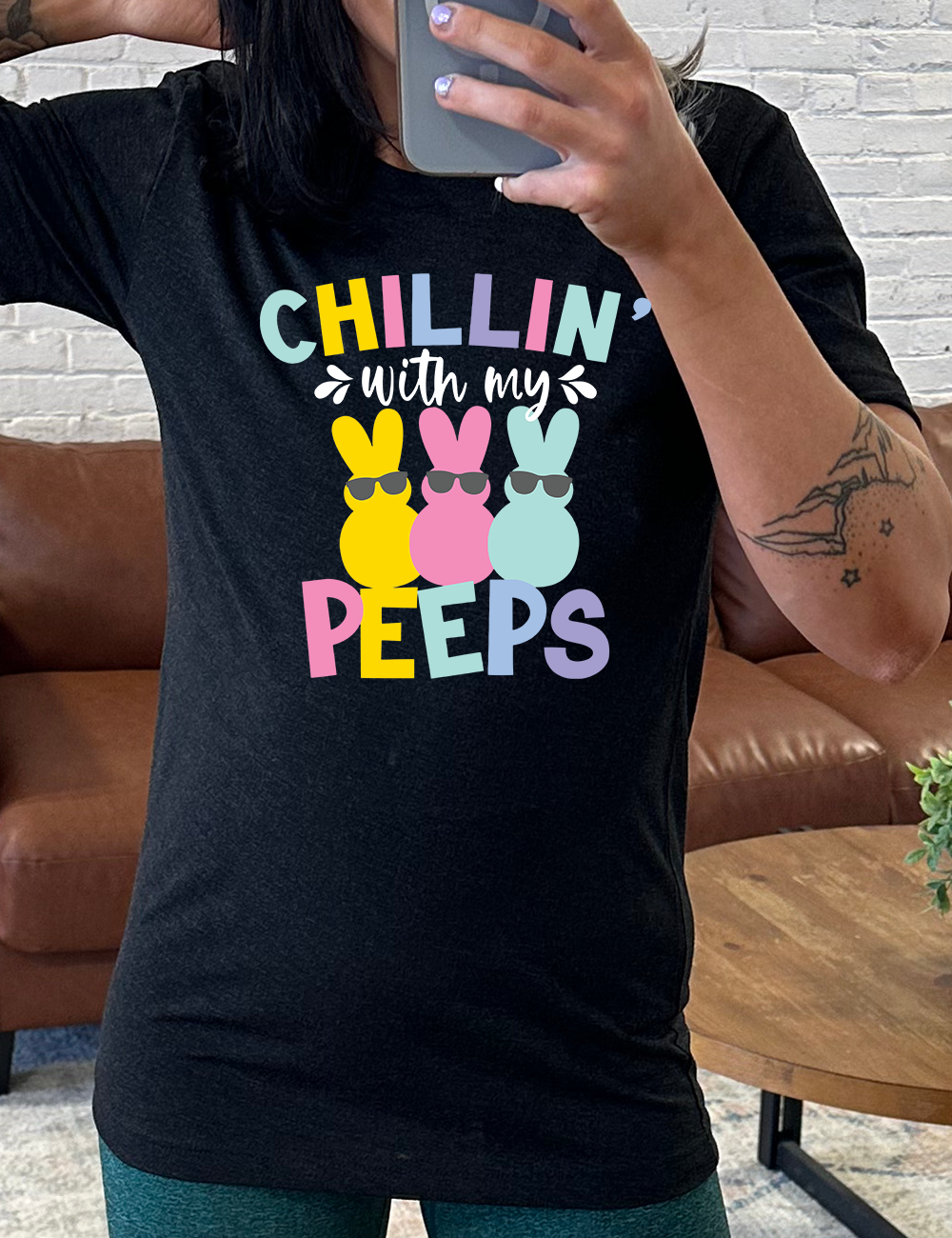 black unisex tee with the words "chillin' with my peeps" on it, with the graphic of three candy peeps wearing sunglasses