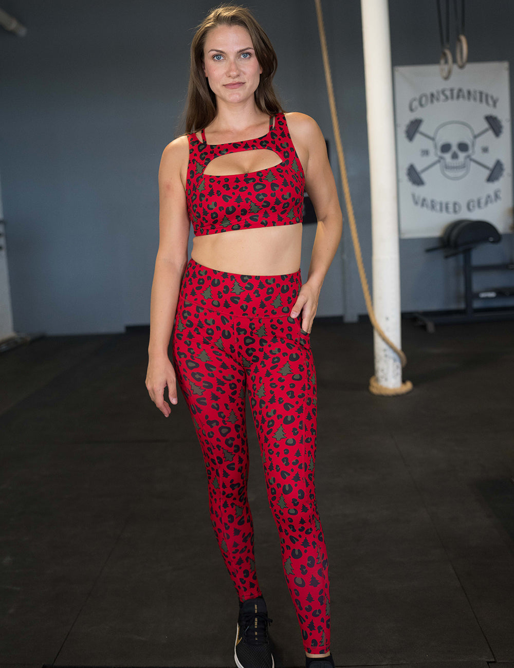 model wearing the red and brown Christmas trees and leopard print full length leggings and sports bra