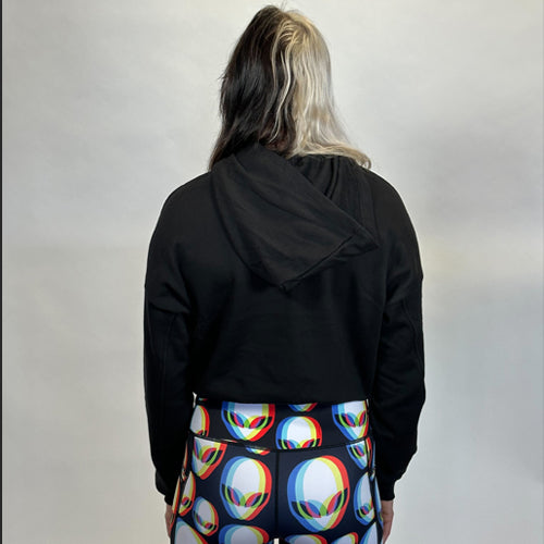 back view of a model wearing a cropped black hoodie