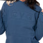 close up of the navy cvg logo embossed hoodie