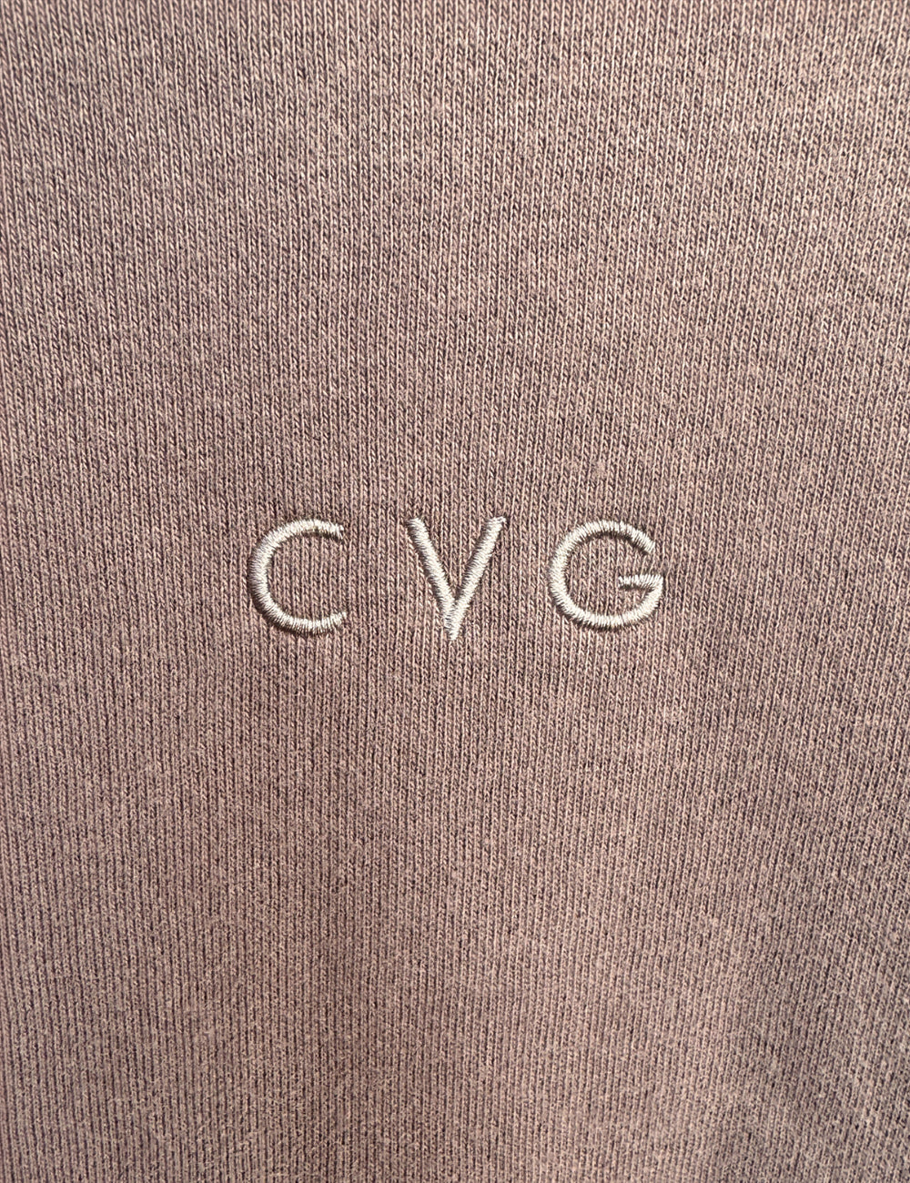 close up of the subtle CVG logo found on the cocoa unwind hoodies and sweatpants