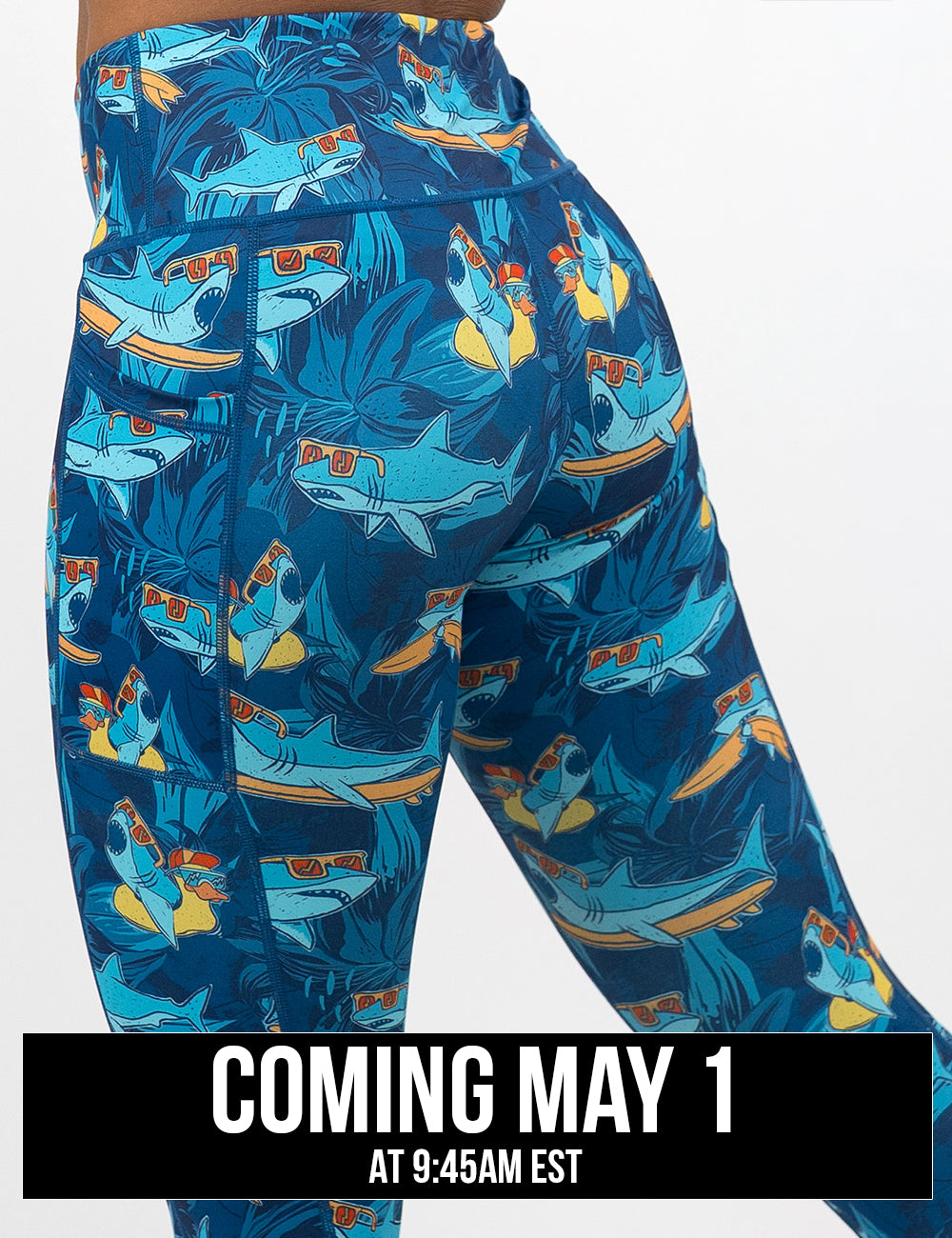 back of the cartoon sharks surfboarding with sunglasses leggings against a white background, coming may 1st