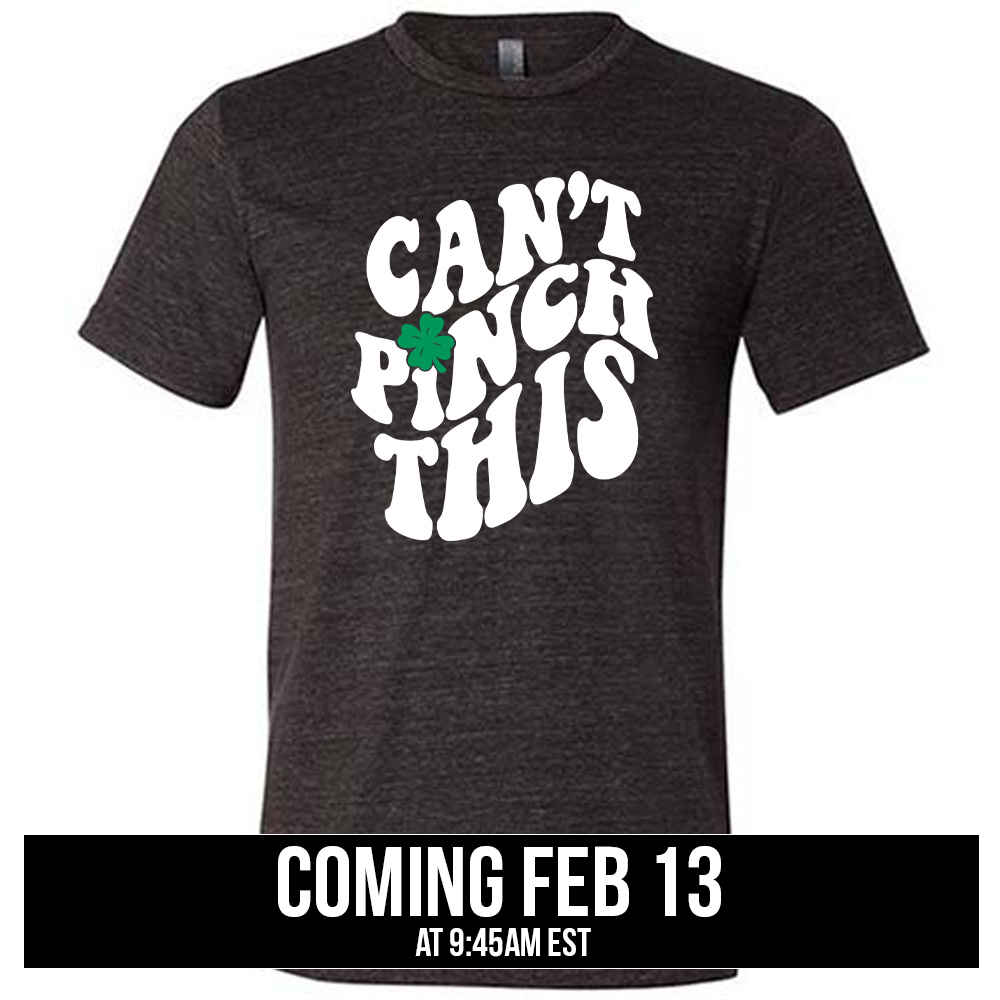 black unisex tee with the words "can't pinch this" with a clover above the "i" of "pinch", coming soon