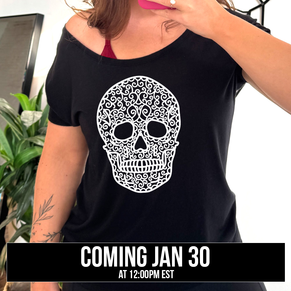 black slouchy tee with the graphic of a large lacy skull, coming soon