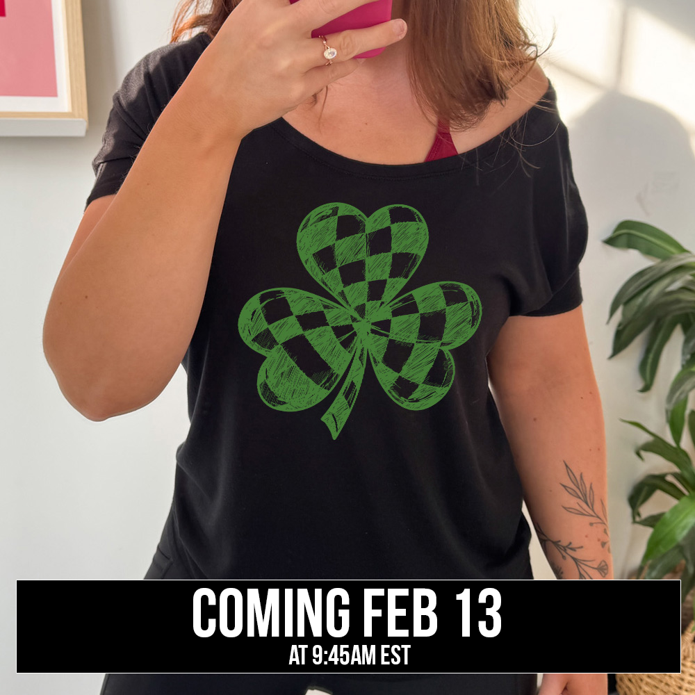 black slouchy tee with the large graphic of a shamrock that is checkered on the inside, coming soon