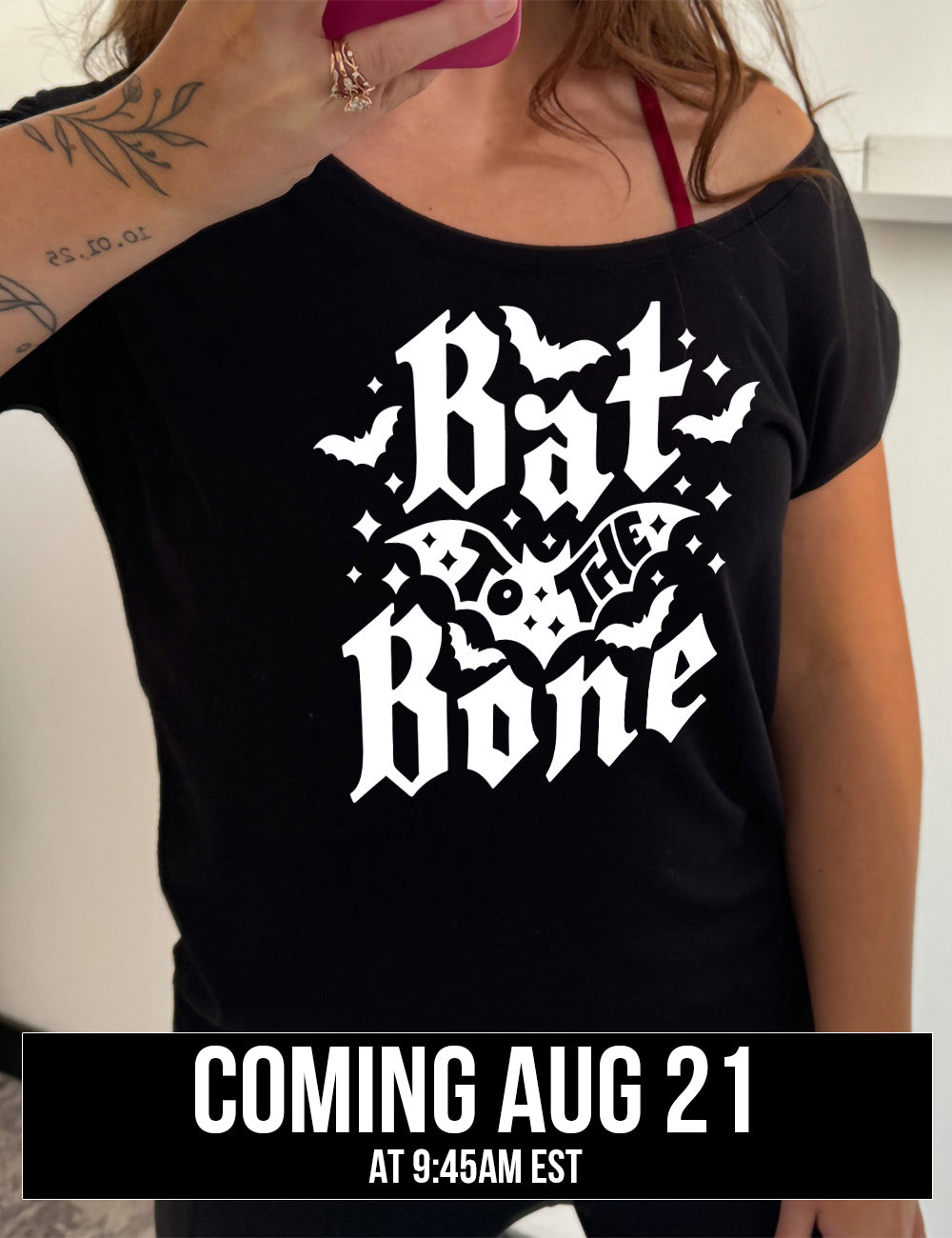 black slouchy tee with the words "bat to the bone" on it, with the words "to the" on top of a bat, and a number of other bats around the words, as well as some stars, coming august 21st
