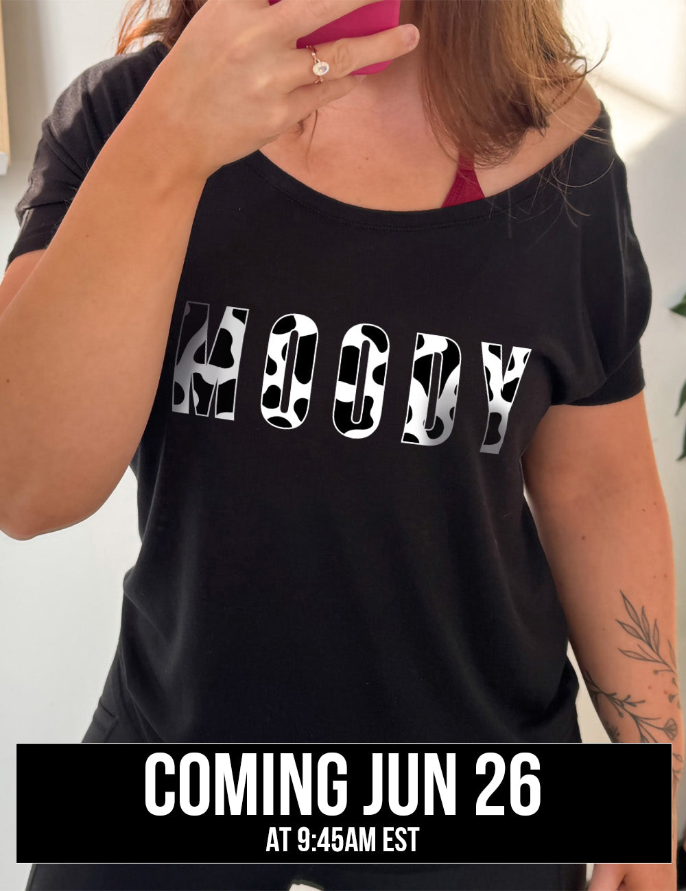 black slouchy tee with the word "moody" in all caps on it, with the font being cow print, coming june 26th