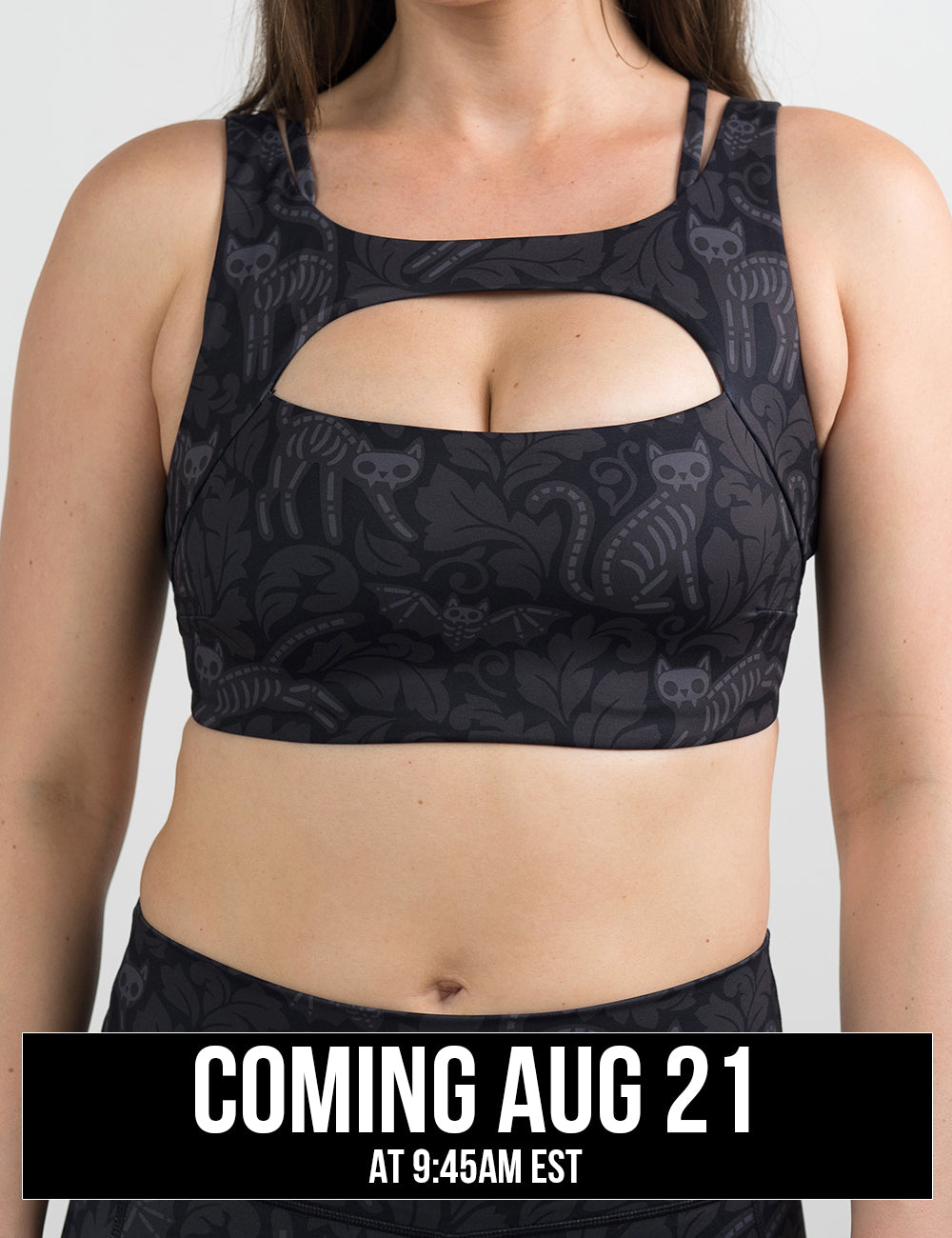 front of the black and grey bats and cats skeleton bra against a white background coming august 21st