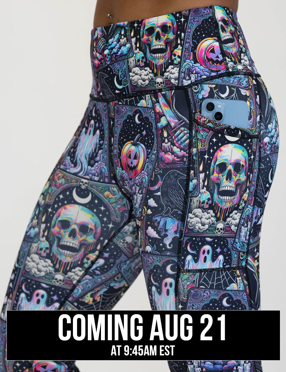 close up of the rainbow skulls, jack o lantern, and ghosts leggings with a phone in its pocket, coming august 21st