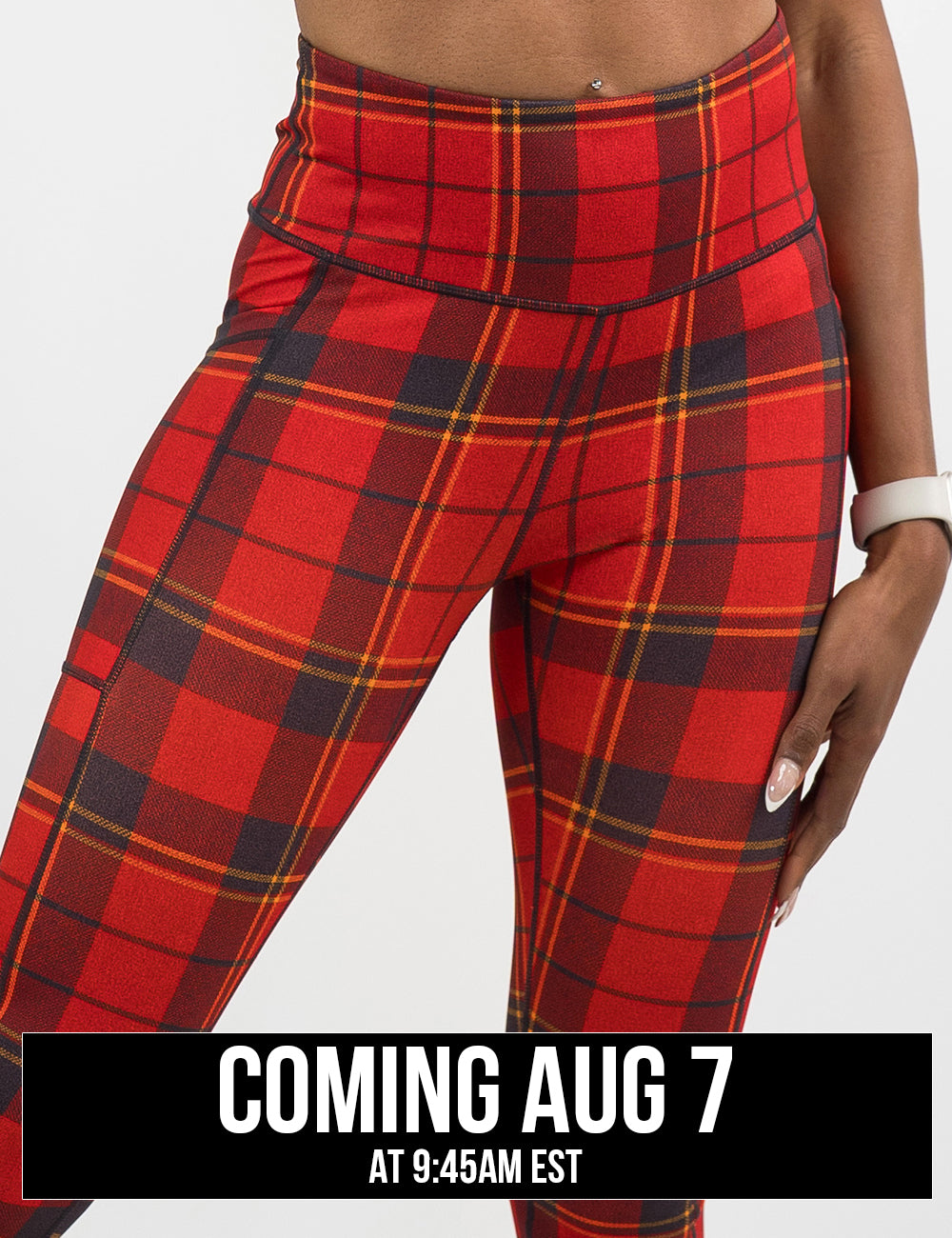 front of the red, yellow, and dark grey plaid leggings coming august 7th
