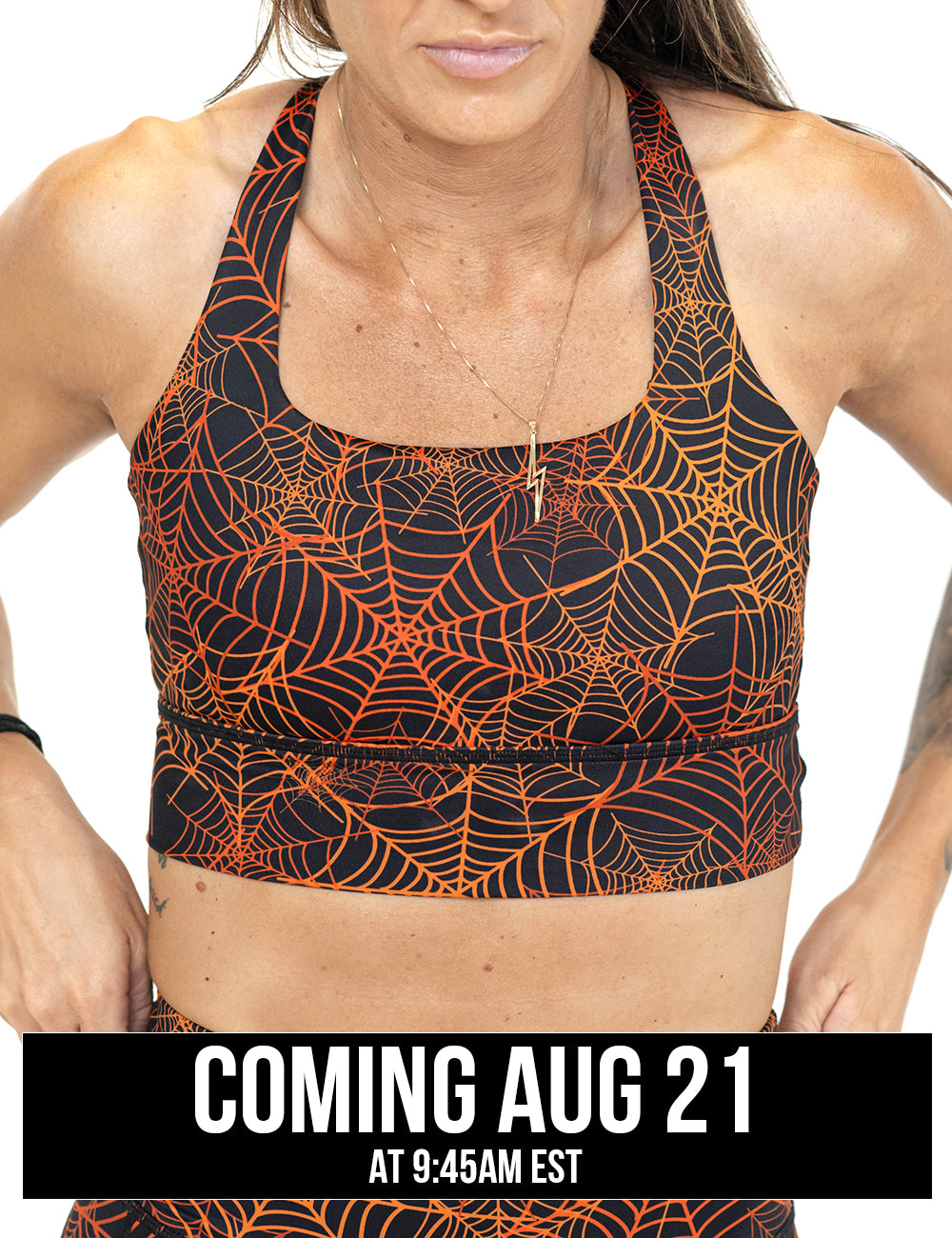 front of the orange spider webs against a black background sports bra coming august 21st