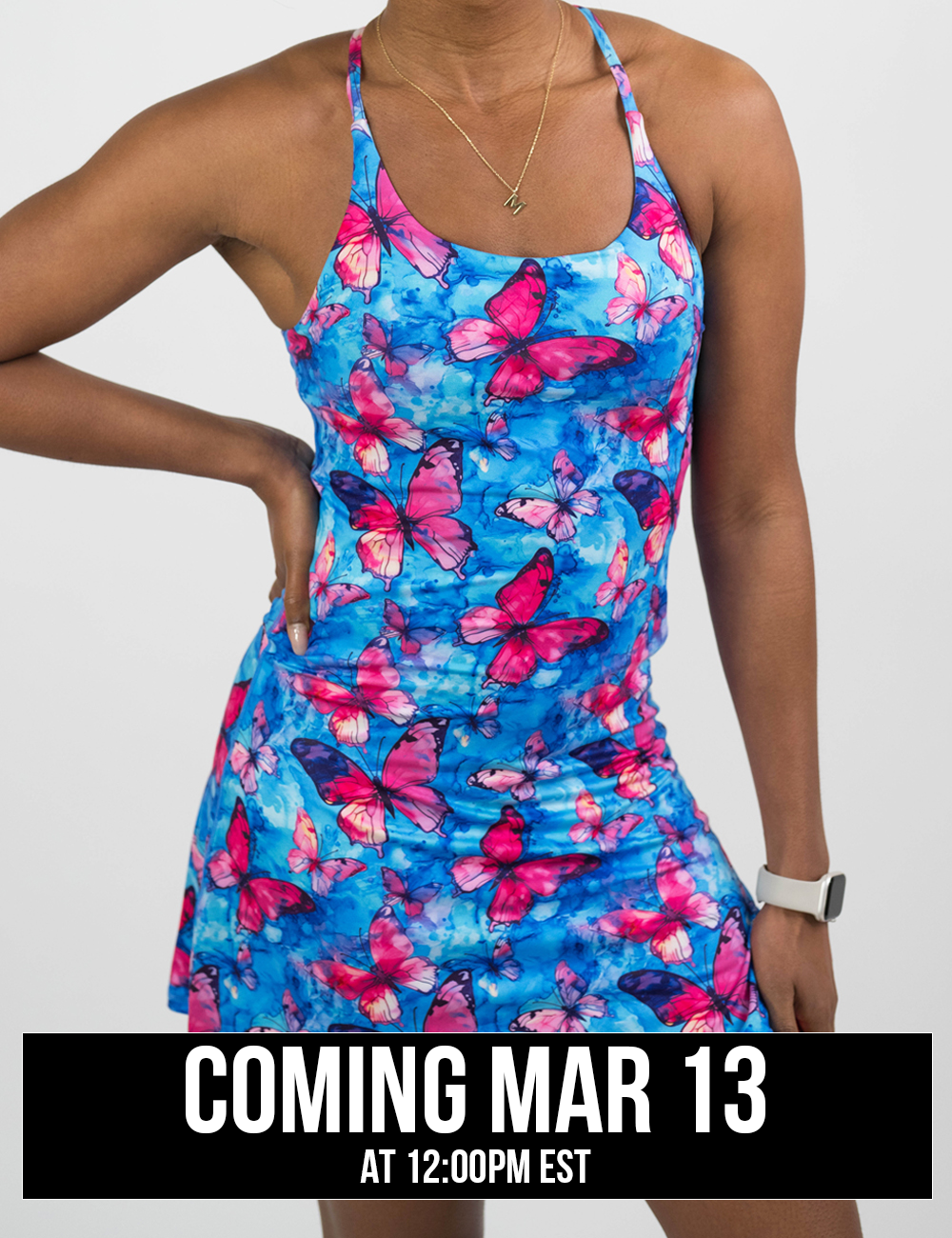 Woman wearing a blue and pink butterfly-patterned dress on a white background coming soon