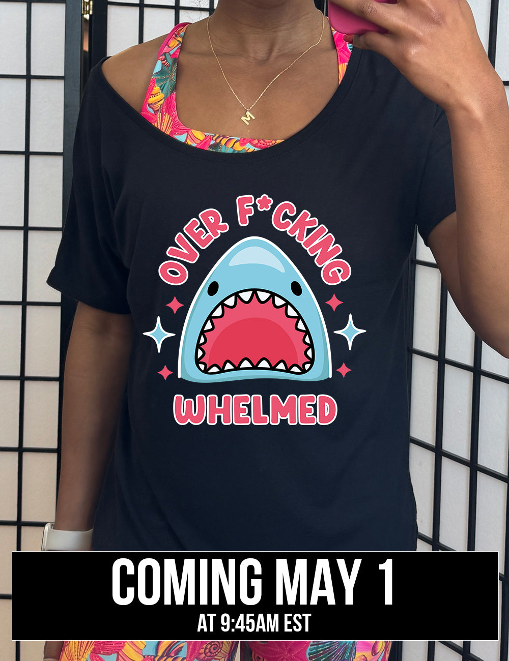 black slouchy tee with the graphic of a shark's head with mouth wide open, and the words around the graphic saying "over f*cking whelmed" and a few stars on the sides, coming soon