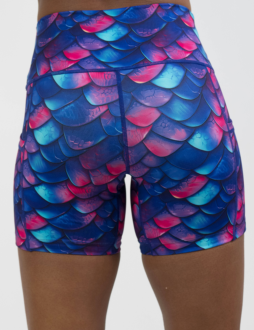 back of the blue, purple, and red colored dragon scale 5 inch shorts against a white background