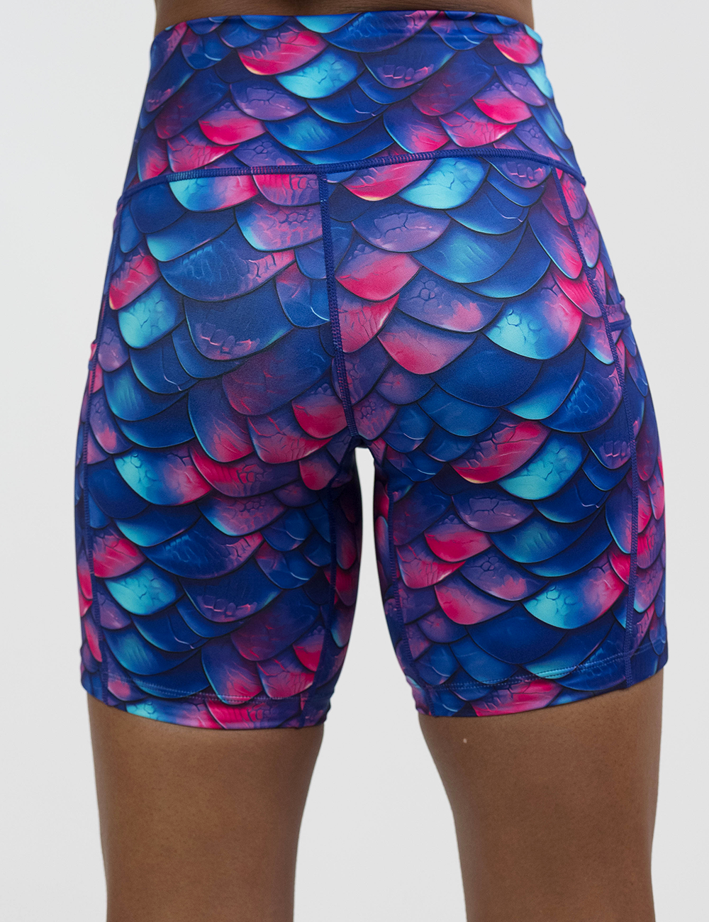 back of the blue, purple, and red colored dragon scale 7 inch shirts against a white background
