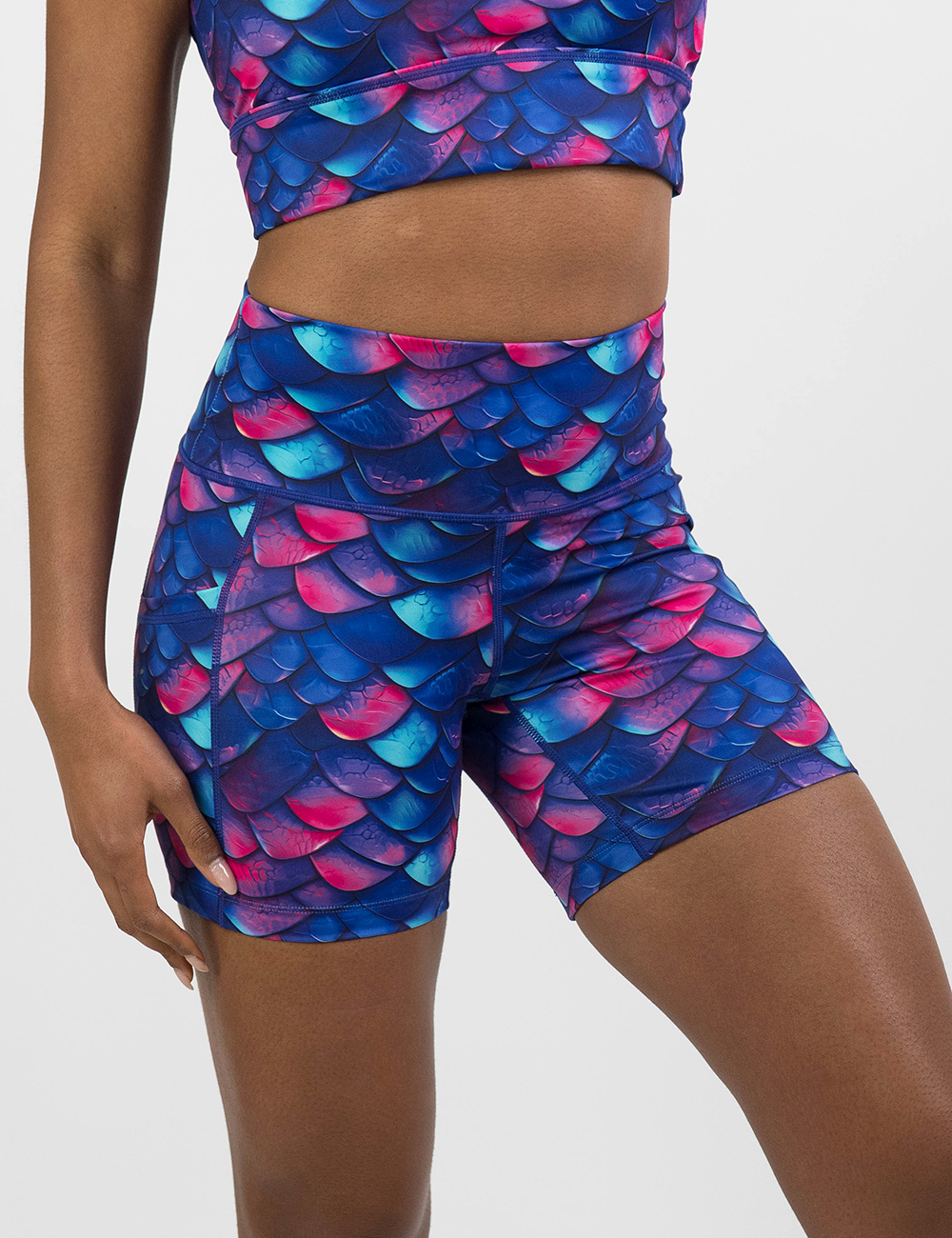 close up of the blue, purple, and red colored dragon scale 5 inch shorts against a white background