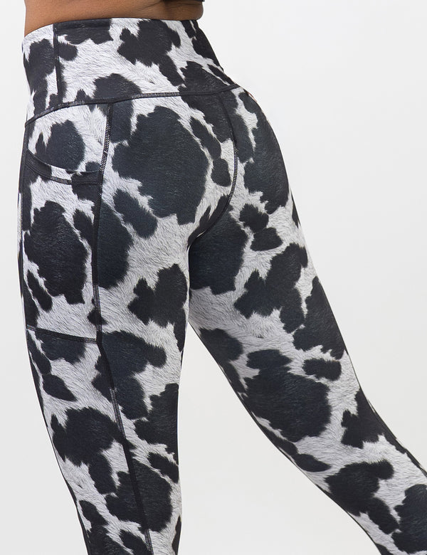 back of the cow print leggings against a white background
