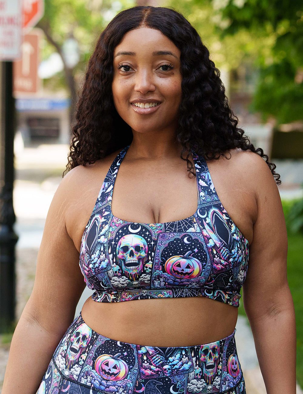 model wearing the rainbow skulls, jack o lantern, and ghosts bra 