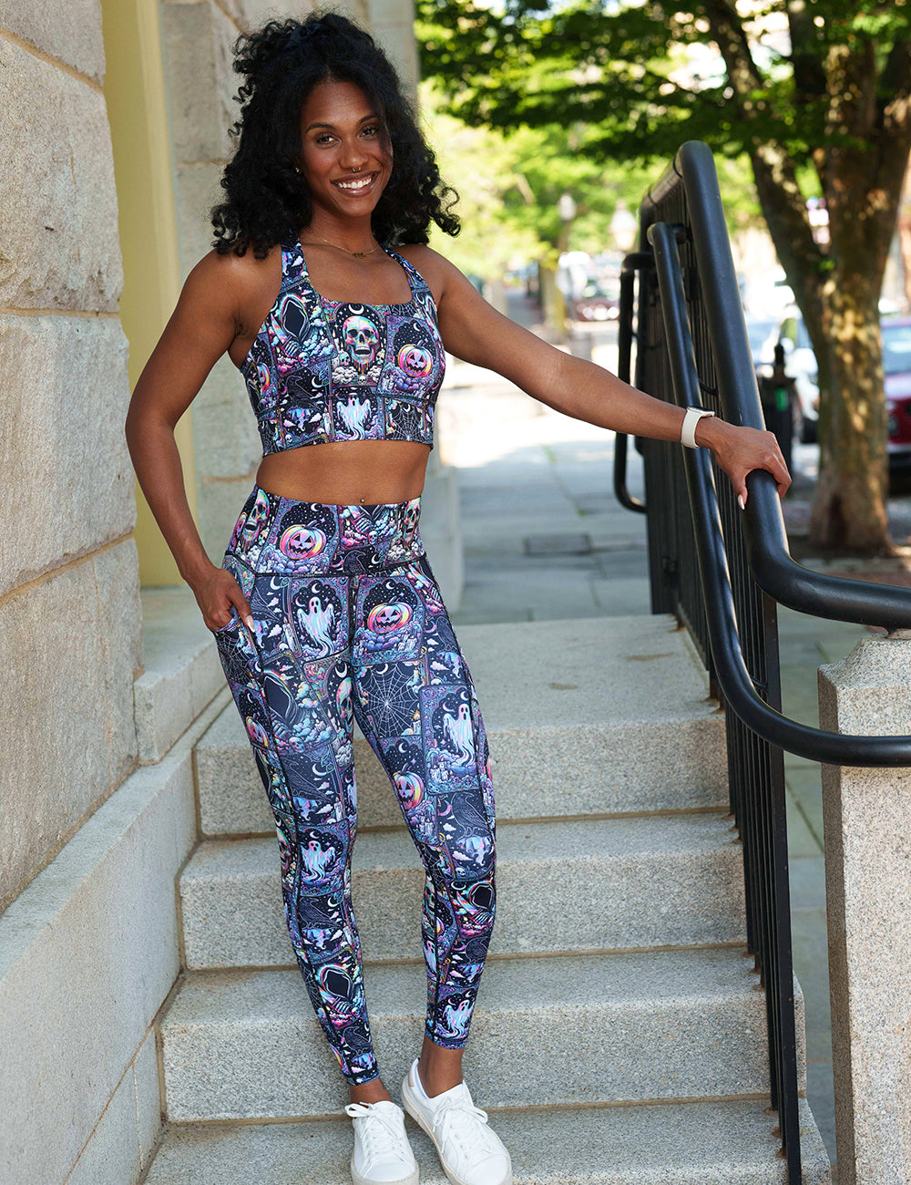 model wearing the rainbow skulls, jack o lantern, and ghosts full length leggings and bra 