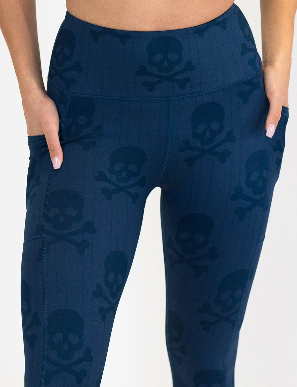 front of the blue skull and bones patterned leggings against a white background