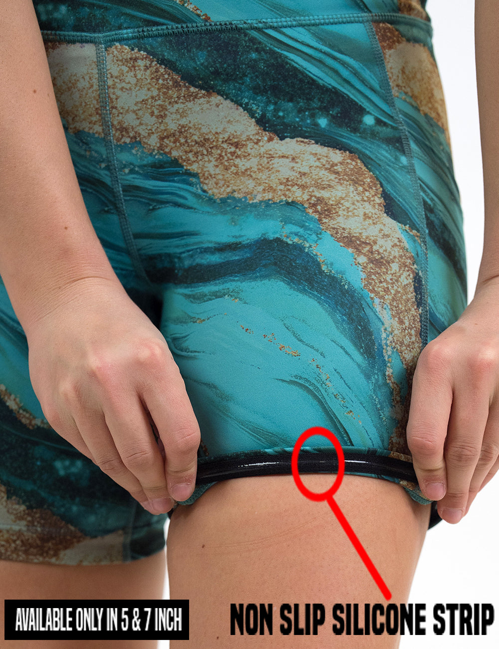 close up of the  blue ocean with gold streaks patterned shorts being rolled up to show the non slip silicone strip found in the 5 and 7 inch inseam lengths