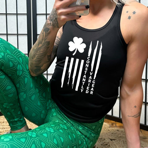 model wearing the black racerback tank top with a clover flag graphic on it in white