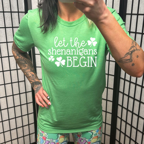 green unisex shirt with the saying "let the shenanigans begin" on it in white