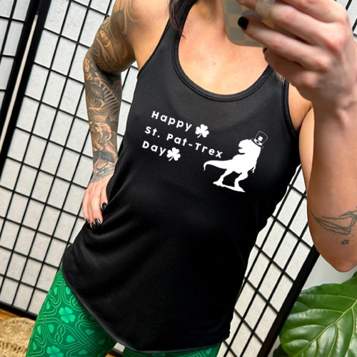 model wearing the black racerback tank top that has a dinosaur and clover graphic on it