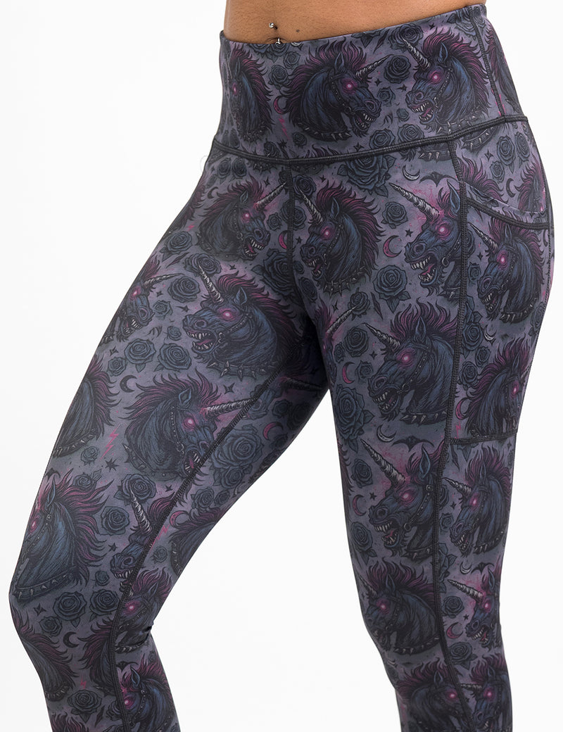 front of the dark unicorn leggings against a white background