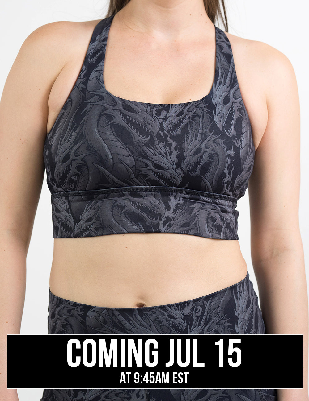 front of the black longline bra with a grey dragon pattern against a white background, coming july 15th