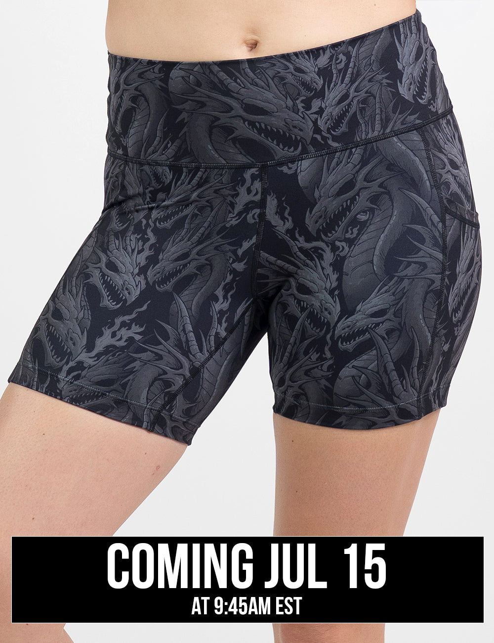 model wearing the 5 inch black shorts with a grey dragon pattern against a white background, coming july 15th