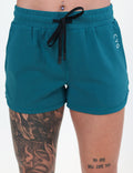 front of the teal shorts against a white background