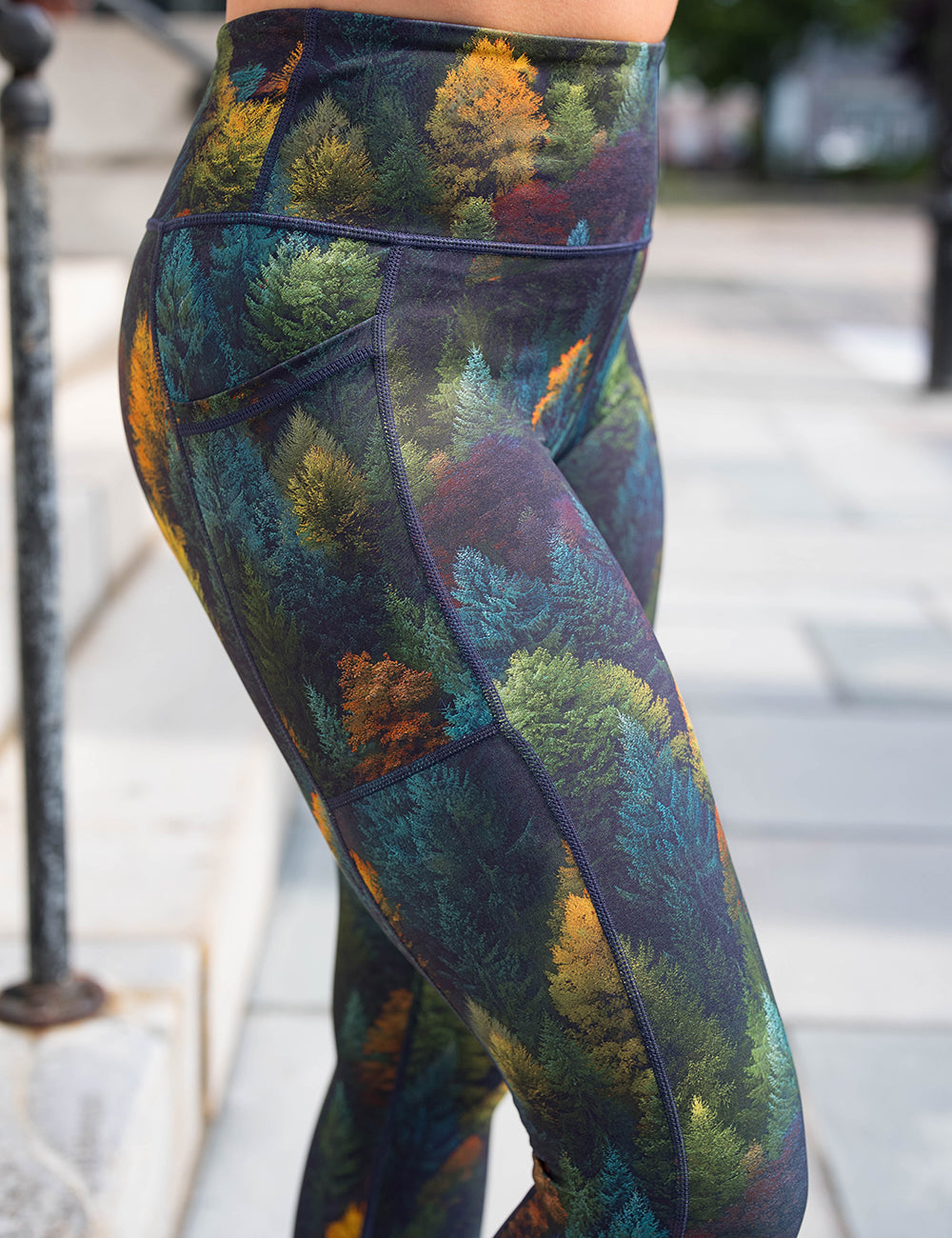 close up of the orange, green, and bluish green trees leggings