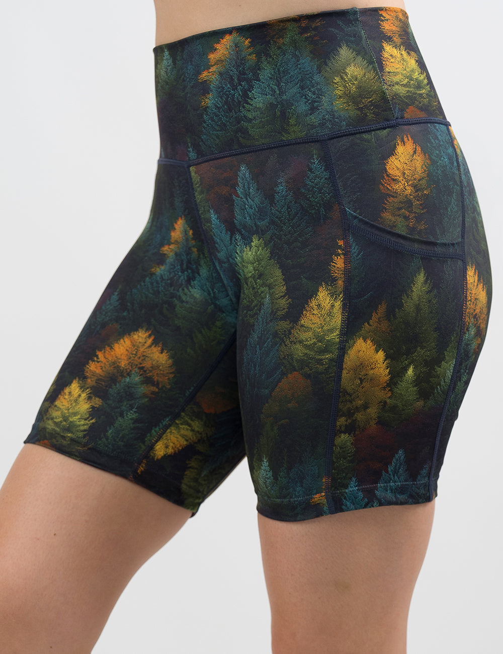front of the 5 inch orange, green, and bluish green trees shorts against a white background