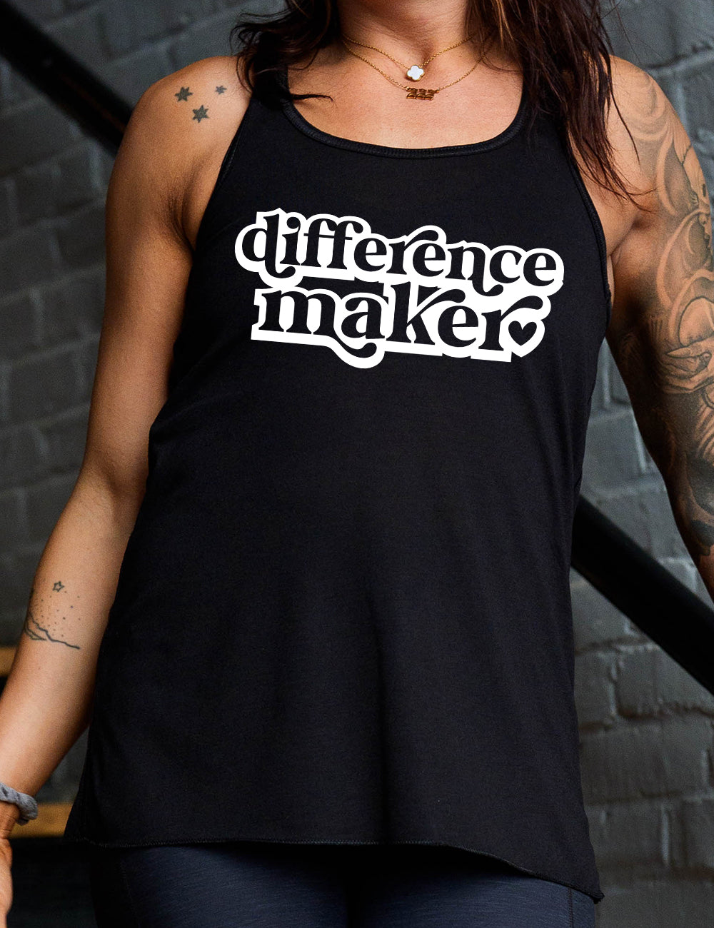 black racerback flowy tank with the words "difference maker" followed by a single heart on it