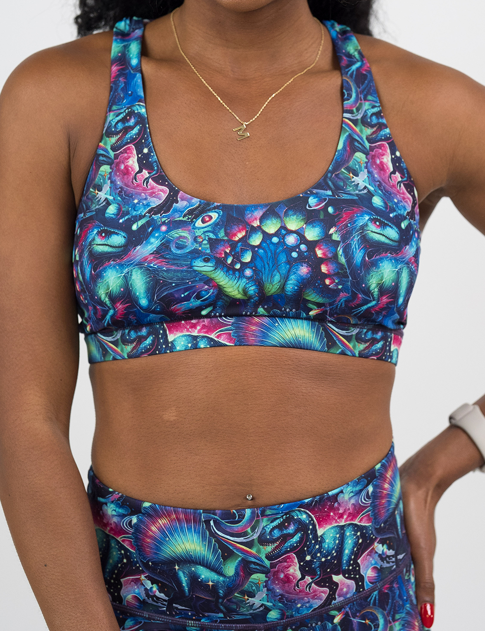 front of the colorful dinosaur pattern butterfly back bra against  a white background