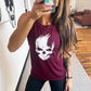 Model wearing a maroon muscle tank with a skull design on the front in white