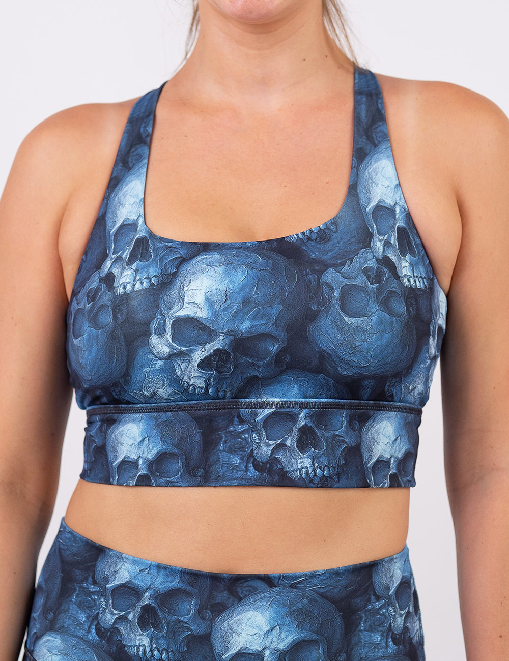 front of the cool blue skulls sports bra against a white background