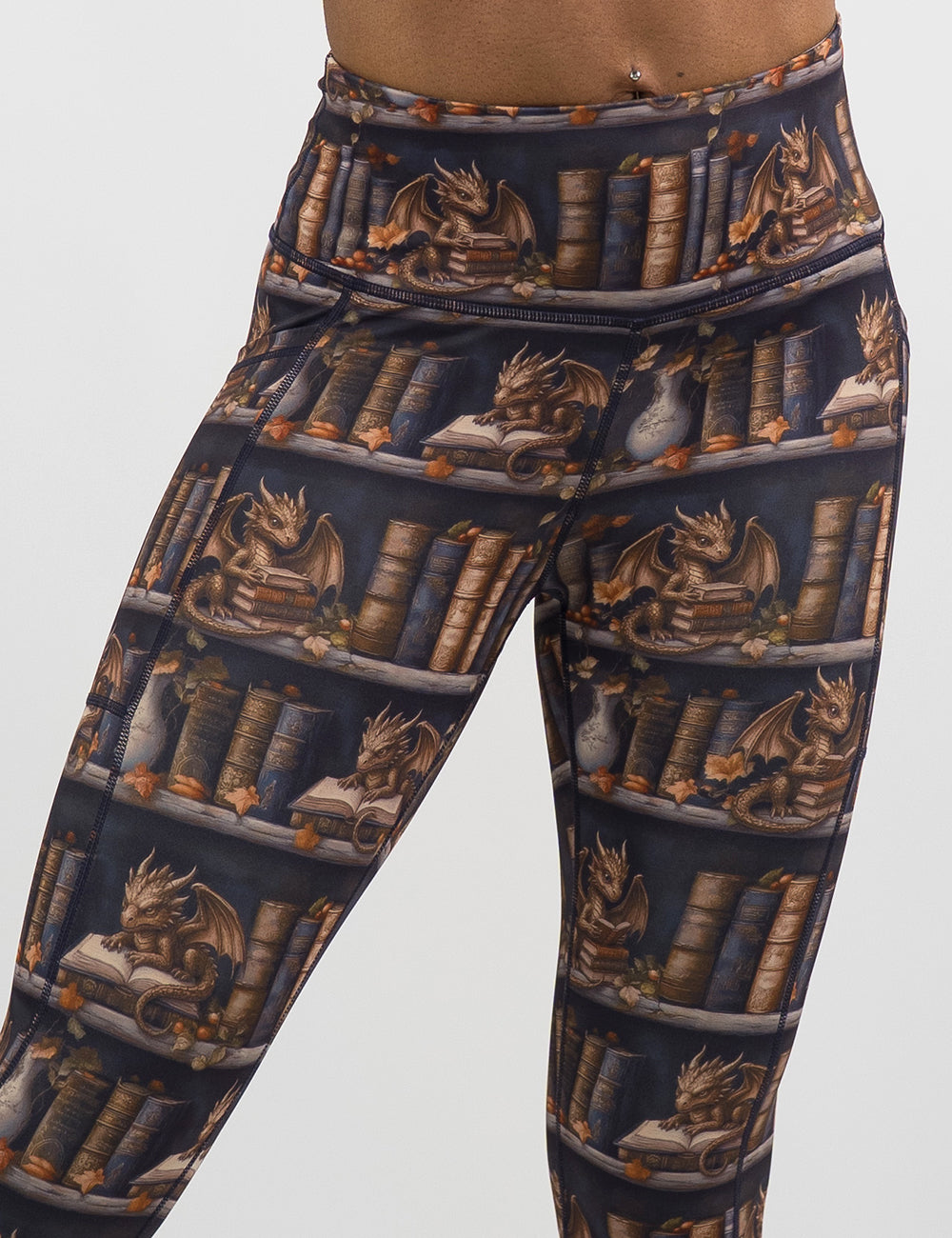 close up of the gold dragons reading books leggings against a white background